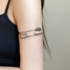 Stylish silver double-layer metal armlet with waterdrop accents worn on upper arm detail view