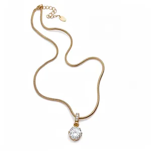 Elegant gold snake chain necklace with sparkling round zircon pendant on white background