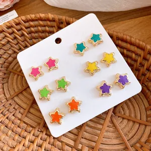 Close-up of a 12-piece colorful enamel star stud earrings set on a white display card