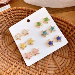 Close-up of a 12-piece set of colorful star-shaped stud earrings on a card