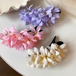 Elegant fabric flower duckbill hair clips with dew drops in various soft colors.
