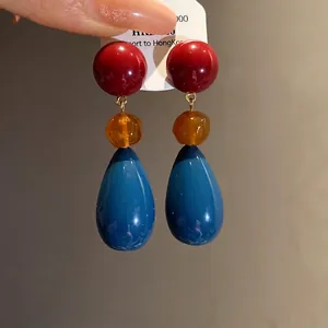 Elegant vintage resin teardrop earrings with red, amber, and blue color blocking design