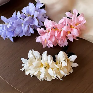 Fabric flower hair clips collection in purple, pink and cream colors for styling