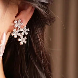 Elegant flower cluster clip-on earrings with shimmering zircon inlays for women.