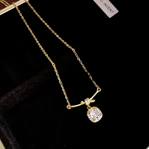 Macro detail of 14K gold plated necklace with brilliant square cushion-cut zircon pendant