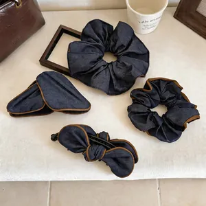 Detailed macro view of vintage denim fabric scrunchies and elegant bow hair clip set