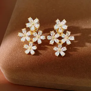 Close-up of sparkling zircon flower ear clips with 18K gold plating for non-pierced ears.