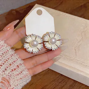 Elegant French style floral stud earrings featuring central pearl and sparkling zircon border