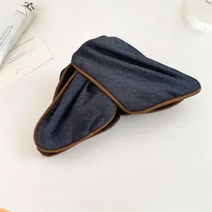 Close-up detail showing the blue denim texture of this elegant fabric hair clip for women
