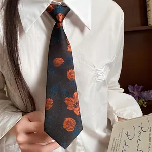 Close-up of vintage cloth necktie with orange and blue embroidered floral pattern