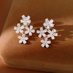 Exquisite detail of zircon flower clip-on earrings with 18K gold plating on velvet