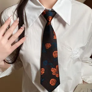 Vintage floral embroidered necktie choker on a white shirt, elegant retro accessory.