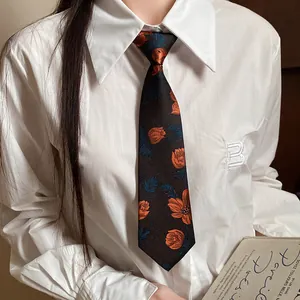 Detailed view of a handmade floral embroidered vintage necktie styled on a white collared shirt
