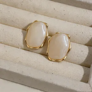 Detail shot of elegant Maillard style resin oval earrings with gold wrinkled edges