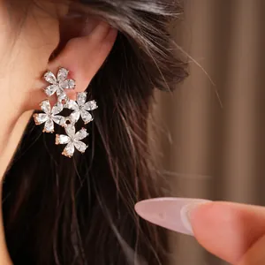 Close-up of elegant 18K gold plated zircon flower clip-on earrings for women