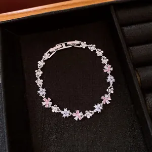 Silver floral bracelet with pink zircons and pearls on black velvet
