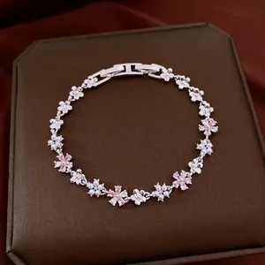 Elegant silver-toned floral bracelet featuring pink cubic zirconia and pearl accents