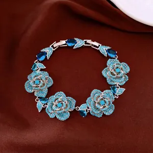 Vintage turquoise flower bracelet with teardrop gemstones on brown satin background