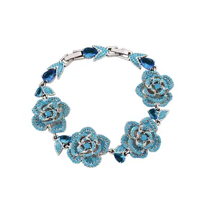 Vintage-style silver-tone bracelet featuring turquoise roses and blue teardrop stones