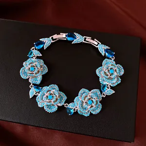 Close-up detail of a vintage silver flower bracelet adorned with sparkling blue crystals
