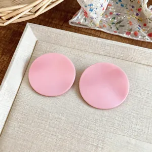 Macro detail view of pink textured round stud earrings in a sweet, trendy Korean style.