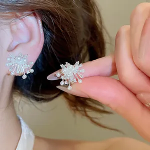 Close-up detail of the elegant zircon and pearl firework design on clip-on earrings