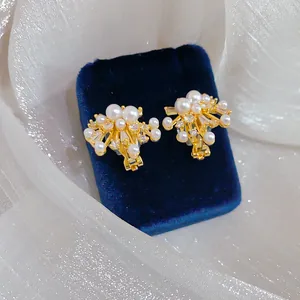 Elegant 18k gold plated firework ear clips featuring white pearls and sparkling CZ stones