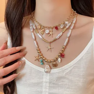Detail of a three-layer beach vacation necklace with starfish, shell pendants, and baroque pearls
