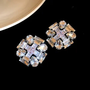 Detail macro view of sparkling silver needle rhombus zircon stud earrings for women