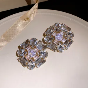 Detailed macro view of silver needle geometric stud earrings with sparkling clear zircon stones
