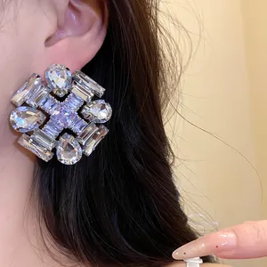 Close-up detail of a large sparkling rhombus earring with clear cubic zirconia crystals