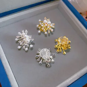 Detailed view of 18k gold-plated firework clip-on earrings featuring pearls and zircons