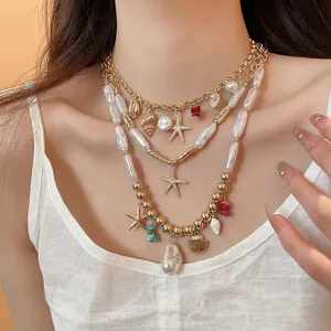 Close-up of a multilayered beach necklace with starfish shell and pearl pendants