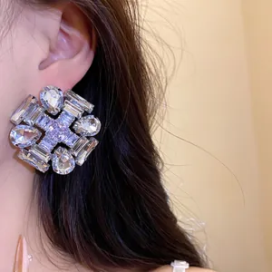 Close-up detail of a large geometric zircon stud earring with sparkling crystal accents