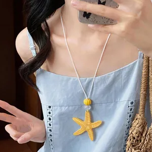 Collana con pendente stella marina in resina giallo vivace per vacanze estive.