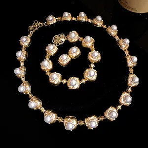 Detail view of vintage baroque pearl jewelry set including necklace, bracelet and earrings