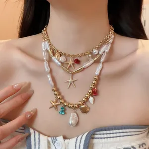 Detailed view of a layered necklace featuring starfish, seashells, and baroque pearls