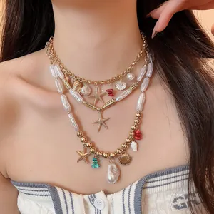Detailed macro view of bohemian beach necklace with starfish and pearl shell pendants