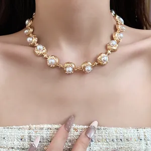 Close-up of vintage court style pearl necklace on model's neck