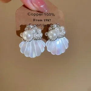 French style shell and pearl earrings with iridescent finish for vacation wear.
