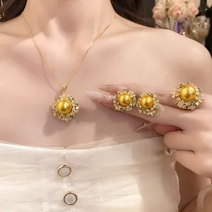 Close-up of a vintage 18k gold plated pearl jewelry set including necklace earrings and ring