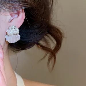 French style pearl and shell flower stud earrings for an elegant island resort look.