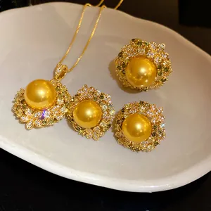 Detailed close-up of a luxurious vintage style golden pearl jewelry set with green zircons