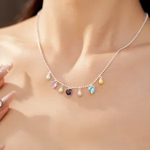 Exquisite silver necklace with colorful heart-shaped zircons and round pearls worn by model