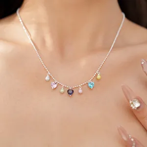 Detailed view of dainty necklace with colorful heart-shaped cubic zirconia and pearls