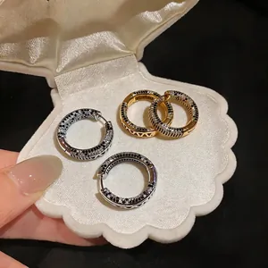 Elegant 18K gold plated hoop earrings featuring black and white cubic zirconia accents