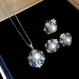 Detail view of a luxury vintage jewelry set featuring large white pearls and colorful zircons