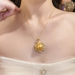 Close-up of an elegant 18k gold plated necklace featuring a large golden pearl pendant