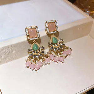 Close-up of vintage resin tassel earrings with gold finish and bead details