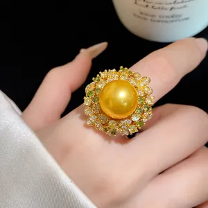 Close-up of a vintage 18k gold plated ring featuring a large golden pearl and zirconia